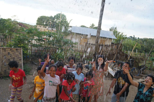 Rachel Grant showing snow to Aetas of the Philippines